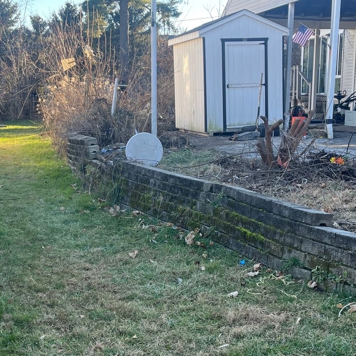 Before, retaining wall and side yard.