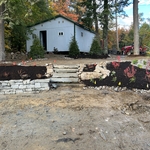 The front view of the main retaining wall in the separating the garage and the parking area for the camp.