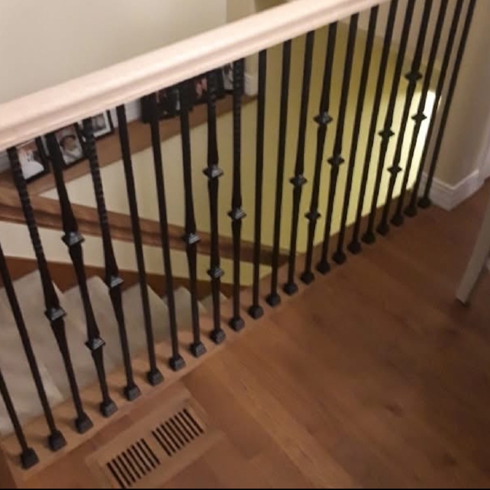 New wooden railing and black balusters
