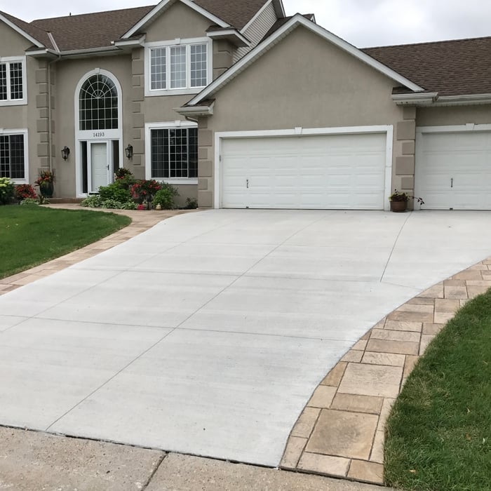 Brushed Concrete Driveway with Stamped Borders – a clean, textured finish paired with decorative edging for a sophisticated and durable entrance to your home.