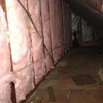 After old insulation is removed, and the knee wall is air sealed, the new insulation is installed on the wall