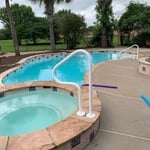 Coated handrails, one for spa and one for pool steps