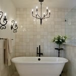 Full shot of stand-alone tub area with antique light fixtures