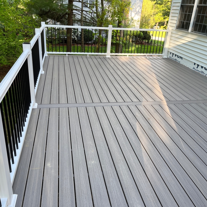 decking and new composite railings with black metal round balusters