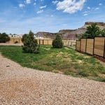 Horizontal picket fence with hog wire fence