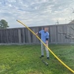 One of are Tech helping installing Poly gas line in the ground