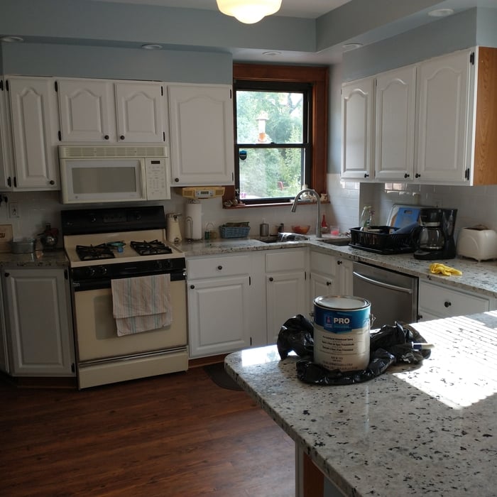 Basic oak kitchen cabinets are transformed by refinishing with Sherwin Williams Industrial Epoxy eggshell sheen sprayed out on the doors and drawer fronts but without spraying in-house.