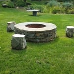 Bluestone fire pit with stools table in the background