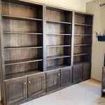 Custom bookshelf with adjustable shelving. We made 15 total shelves but we only have 12 installed for the picture.