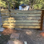 Spraying the front horizontal 6 foot fence in an oil base, semi transparent stain from Lowe’s made by Cabot.