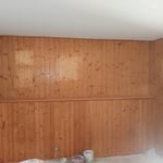 The polyurethane has darkened over the years. You can see where pictures were hung.