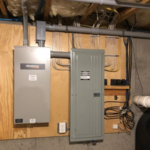 Automatic Transfer Switch Installed - shown on the left with the customers electrical panel on the right.