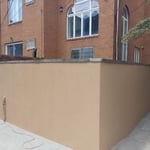 Resurfaced cinder block wall with mesh wiring and cement stucco. Applied acrylic waterproof coating at the end.