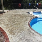 Stamped pool deck with stained borders