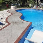 Stamped pool deck with stained borders