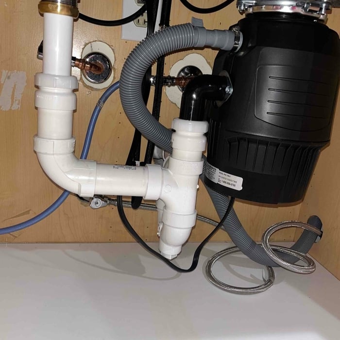 Garbage disposal installed under kitchen sink.