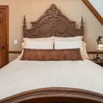 Closet doors that lacked storage were removed & closed off to create the space for this stunning custom headboard