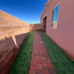 Synthetic grass and brick walkway
