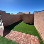 Synthetic grass and brick walkway