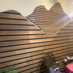 This is done in wood slat with felt backing