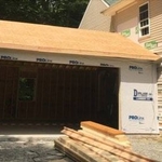 Exterior view of the in-progress attached garage addition build. As you can see, the necessary siding was removed from the existing home so we could attach the garage build.