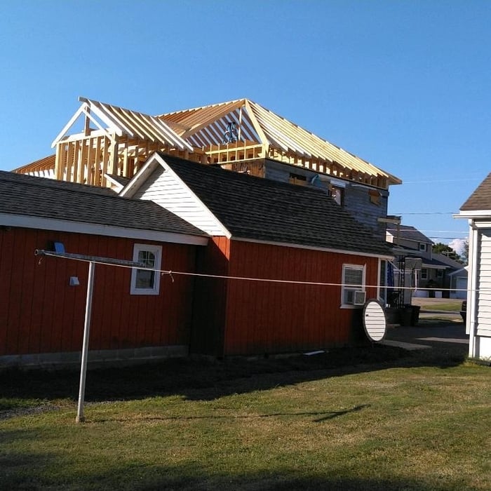 Back view shows how much the new build towers above the existing one-story homes in the neighborhood.
