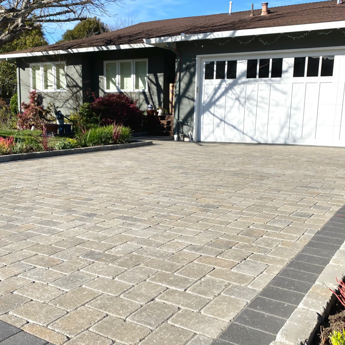 Corte Madera driveway: Belgard Dublin Cobble pavers in Victorian in a 90 degree herringbone pattern with Catalina Grana pavers in Graphite on the border.