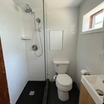 Bathroom remodel: removing the bathtub and building a new shower area with a glass wall panel, installing new flooring and wall tiles, new lighting and shower.
Dark gray flooring and subway tiles for a modern style.