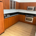 We started with these outdated brown cabinets and this dull black granite countertop.