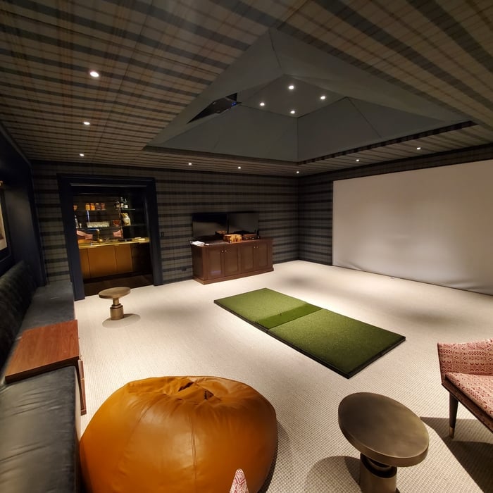 What house is complete without a bar and golf simulator room?
