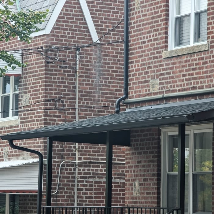Insulated aluminum roof with plywood and shingles and gutter drainage