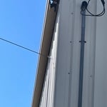 Before and after R panel re fastening and downspout install