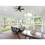 The sunporch easily accommodates both outdoor conversation seating and dining sets. Finishing the comfortable indoor/outdoor living space, electrical wiring provides power for the ceiling fan and can lights above, with additional outlets for a TV, speakers and other items—everything the homeowners need to enjoy a fresh, inviting living area.
