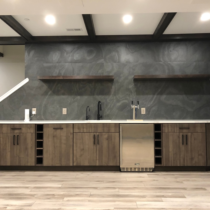 wet bar with slate backsplash and floating shelves