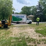 Trencher pulled up and ready to lay pipe at a sprinkler install