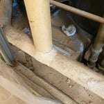 Behind wall, asbestos wrapped pipe.