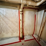 Asbestos wrapped cast iron pipe prior to abatement