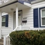 Flat roofed porch with Custom vinyl shutters