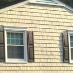 Custom Cedar Shake Vinyl Siding with custom window mantels and shutters