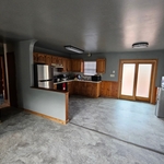 Kitchen- removed wall paper and vinyl flooring. Painted, installed new trim and flooring