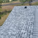 New ridge cap shingles installed to valley peak. Valley is a closed shingle valley style.