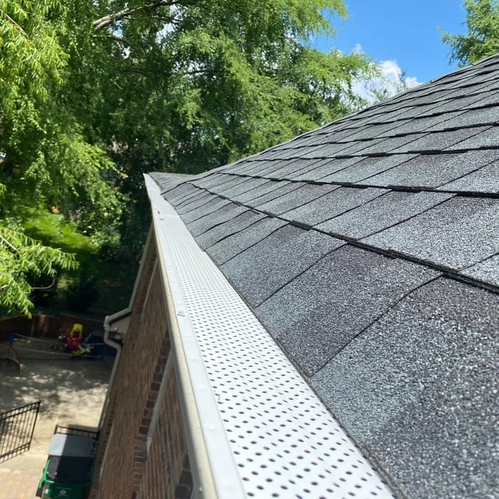 Gutter screen installation on residential home in Charlotte, NC by Signature Exteriors, a roofing and gutter company.