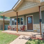 This is a gut and rehab combination of green siding and sand contrast color in stone and soffits