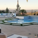 New pool, fire pit, seating walls, concrete pool deck with artificial turf in-lays, and patio pavers