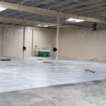 Plastic is laid out to protect the freshly pained walls and floor.