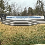 Custom contouring pool stairs in trex rocky harbor with matching fascia