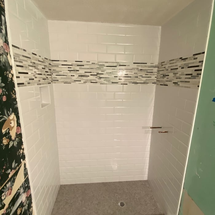 4x8 stacked broken joint tile with mosaic inset with penny shower floor install