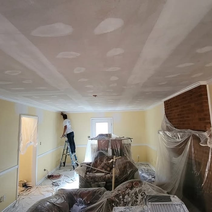 Removing the popcorn texture down to the drywall.