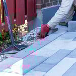 Laying down pavers by hand brick by brick.