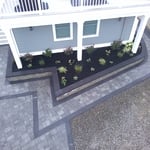 Beautiful paver driveway, walkway, garden retaining wall and plantings.